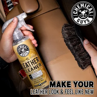 Hands spraying leather cleaner on a tan car seat with a brush; Chemical Guys logo.