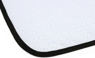 White textured mat corner with black trim on a white background