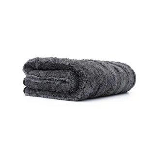 Rolled dark gray towel on a white background