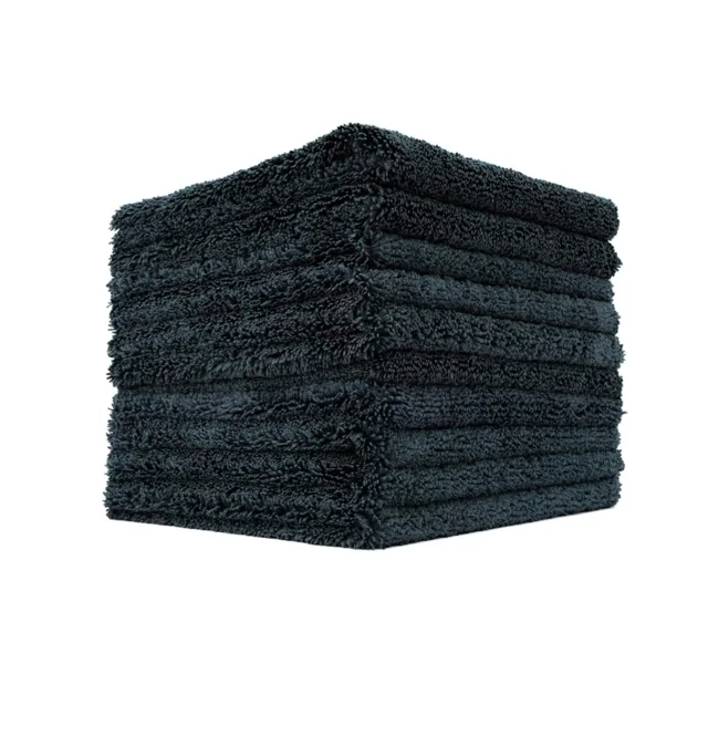 Stack of dark gray folded towels on a white background
