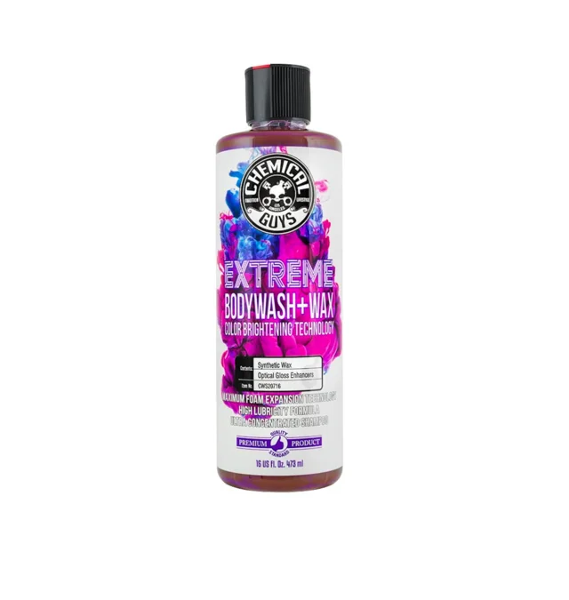 Bottle of purple Extra Moisture shampoo with black cap on white background