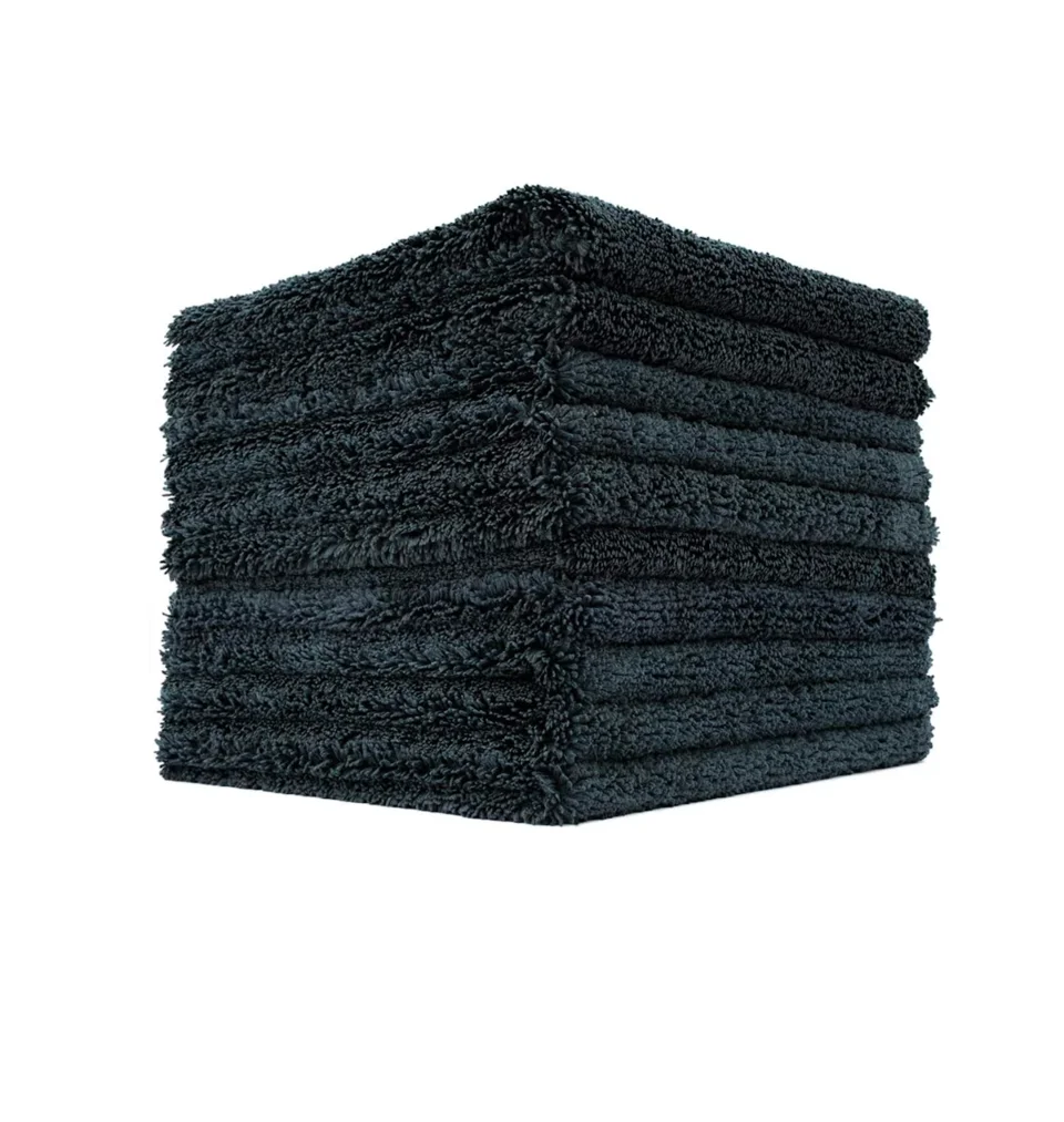 Stack of dark gray folded towels on a white background