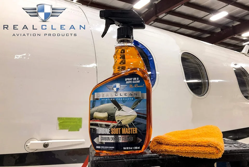 Aviation interior cleaner spray bottle and yellow cloth by a private jet.